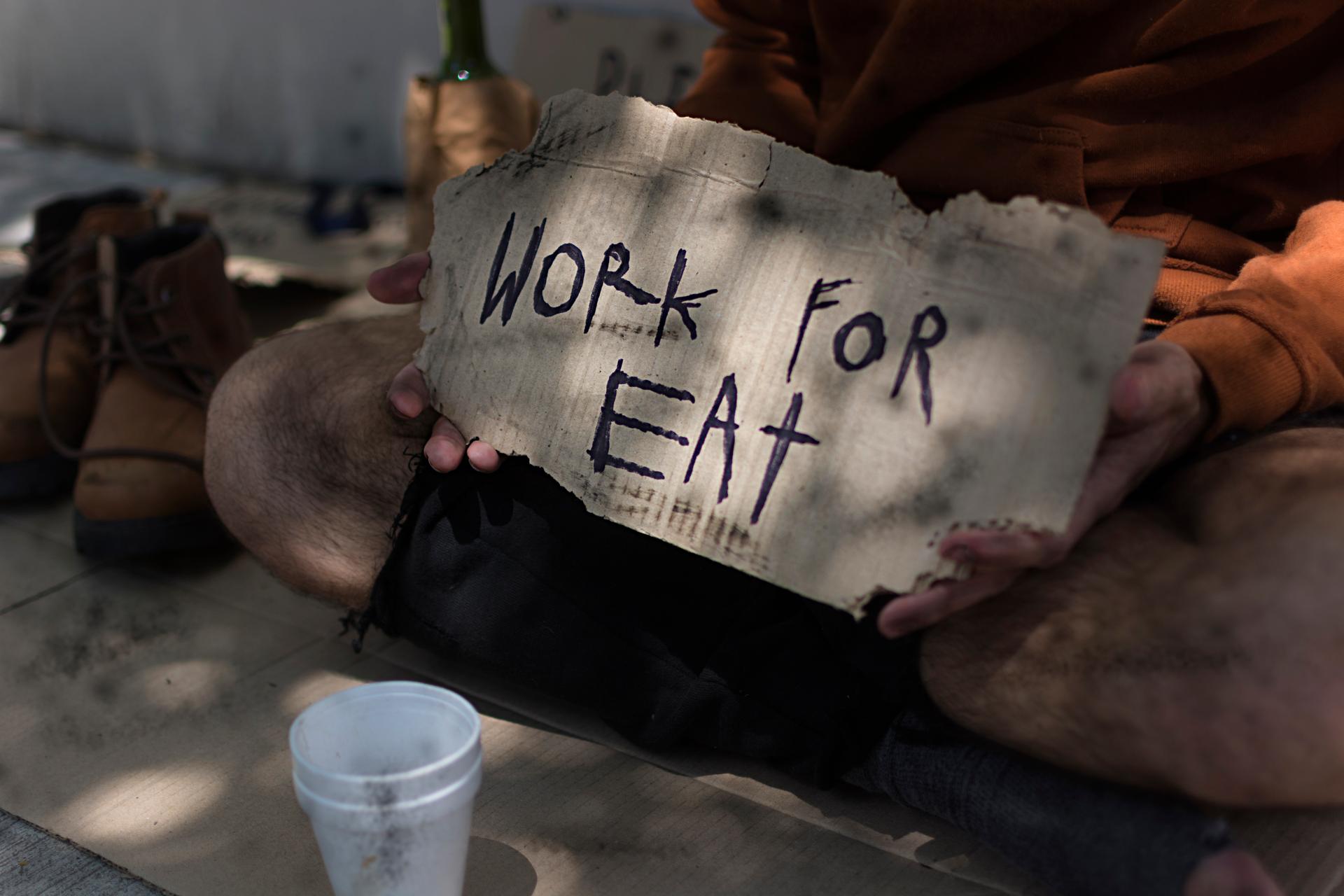 Homeless Man With Work Eat Sign